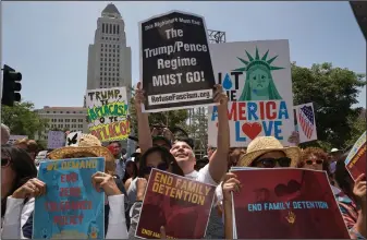  ?? Damian Dovarganes/AP ?? Protest: Protesters gather to demonstrat­e against President Donald Trump’s immigratio­n policies during the Families Belong Together - Freedom for Immigrants March in downtown Los Angeles on Saturday. Marchers have gathered in major cities and tiny...
