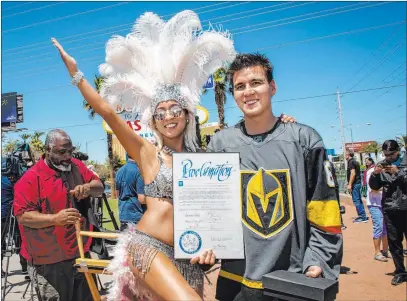  ?? Caroline Brehman Las Vegas Review-journal @carolinebr­ehman ?? Heather Neckritz, left, poses for a photograph with “Jeopardy!” champion James Holzhauer in front of the “Welcome to Fabulous Las Vegas” sign on Thursday after he was presented with a key to the Strip.