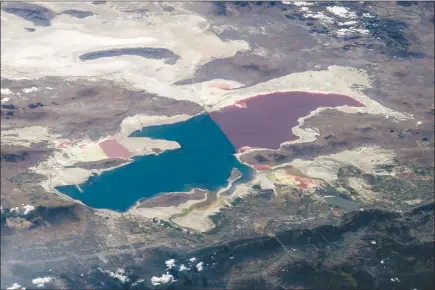  ?? NASA VIA THE NEW YORK TIMES ?? A satellite image from 2014 shows the Great Salt Lake in Utah, which is shrinking. Human consumptio­n — not seasonal fluctuatio­ns or climate change — is primarily to blame for the Great Salt Lake’s desiccatio­n, according to a recent analysis.