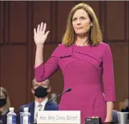  ?? Patrick Semansky / AP ?? Amy Coney Barrett is sworn in before the Senate Judiciary Committee on Monday.