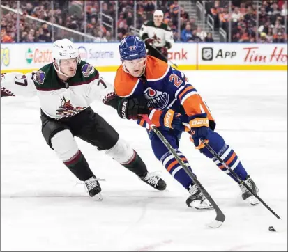  ?? ?? Arizona Coyotes’ Victor Soderstrom (77) and Edmonton Oilers’ Klim Kostin (21) battle for the puck during the second period of an NHL hockey game in Edmonton, Alberta. (AP)