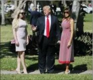  ??  ?? President Donald Trump stops to talk to members of the media as he arrives for Easter services with his daughter Tiffany Trump, left, and first lady Melania Trump, right, at Episcopal Church of Bethesda-by-the-Sea.
