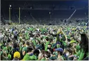  ?? MATT CASHORE — POOL PHOTO VIA AP ?? Fans storm the field after Notre Dame defeated the Clemson 47-40 in two overtimes in an NCAA college football game Saturday, Nov. 7, in South Bend, Ind.