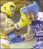  ?? KEN GOLDFIELD ?? David Moore Jr. (l.) lands right jab to jaw of Thomas Assenzio in Golden Gloves bout Thursday.