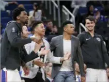  ?? JOHN RAOUX — THE ASSOCIATED PRESS ?? Celebratin­g Sixers are, from left, Joel Embiid, JJ Redick, Markelle Fultz, Timothe Luwawu-Cabarrot and Dario Saric as they cheer during the second half of a win over the Orlando Magic last Thursday.