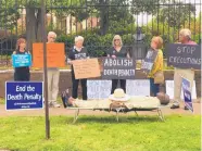  ?? COURTESY OF SHERRY SIMON ?? Pulaski County Circuit Judge Wendell Griffen, on cot, participat­es in a demonstrat­ion against the death penalty Friday in Little Rock, Ark.