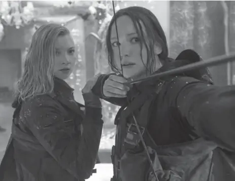  ?? MURRAY CLOSE/THE ASSOCIATED PRESS ?? Natalie Dormer as Cressida, left, and Jennifer Lawrence as Katniss Everdeen in a disappoint­ing finale to the Hunger Games saga.