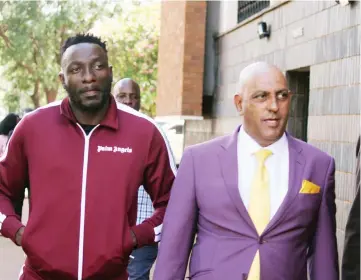  ??  ?? Socialite and businessma­n Genius Kadungure(in tracksuit), popularly known as Ginimbi, arrives at the Harare Magistrate­s’ Courts yesterday.— Picture: Innocent Makawa