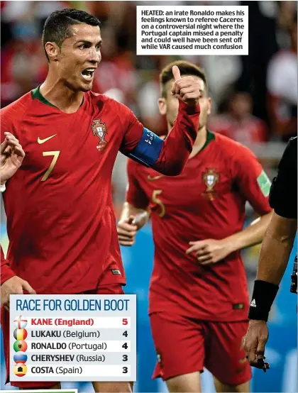  ??  ?? HEATED: an irate Ronaldo makes his feelings known to referee Caceres on a controvers­ial night where the Portugal captain missed a penalty and could well have been sent off while VAR caused much confusion
