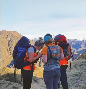  ??  ?? ABOVE LandSAR volunteers are trained in navigation to have good map, compass and GPS skills.