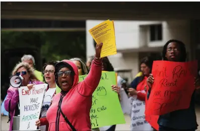  ?? Arkansas Democrat-Gazette/MITCHELL PE MASILUN ?? Demonstrat­ors chant “Housing is a human right” outside a Little Rock hotel where Housing and Urban Developmen­t Secretary Ben Carson was delivering the keynote address Friday at the Fair Housing/Fair Lending Conference. About 20 people attended the rally to protest a proposed 18 percent cut to the HUD budget for 2020.