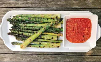  ?? The Associated Press ?? Grilled Asparagus with Romesco Sauce from a recipe by Elizabeth Karmel in Amagansett, N.Y.