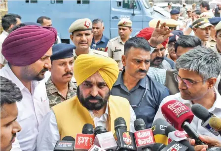  ?? (ANI) ?? Punjab CM and AAP leader Bhagwant Mann speaks to the media outside Tihar Jail after meeting with Delhi CM Arvind Kejriwal, in New Delhi on Monday