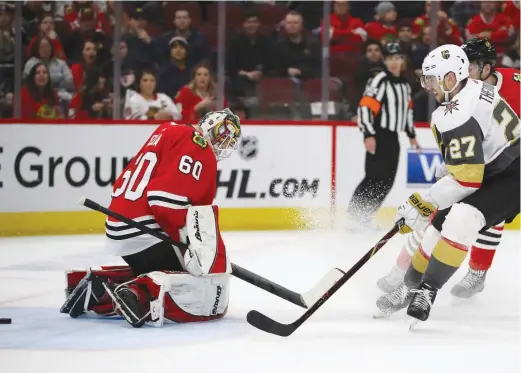  ?? GETTY IMAGES ?? Shea Theodore puts the puck past Collin Delia for the Golden Knights’ winning goal at 1:19 of overtime. The Hawks have tallied 18 points in their last 15 games.