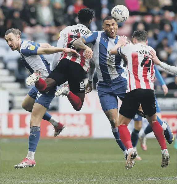  ?? ?? From left, Will Keane, Jay Matete, Josh Magennis and Corry Evans do aerial battle at the DW Stadium.