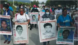  ?? (Henry Romero/Reuters) ?? RELATIVES OF missing students hold posters with their images as they take part in a march to mark the sixth anniversar­y of the disappeara­nce of 43 students of the Ayotzinapa Teacher Training College, in Iguala, in 2020.