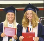  ?? Mona Weatherly ?? Valedictor­ian Macy Brown, left, and Salutatori­an Madison Guest hold their diplimas at Loup County graudation June 27.