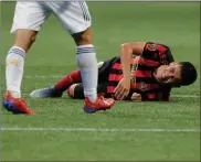  ??  ?? above: Atlanta United midfielder Ezequiel Barco reacts during the second half of an MLS soccer game against the Los Angeles Galaxy, Saturday, Aug. 3, 2019, in Atlanta. left and
Atlanta United fans wave flags and celebrate their team’s first goal in the first half of an MLS soccer game against the Los Angeles Galaxy.