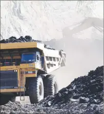  ??  ?? A truck carries a load of coal from a mine