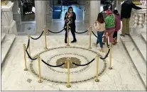  ?? JENNIFER MCDERMOTT - THE ASSOCIATED PRESS ?? Visitors to the Rhode Island State House, in Providence,
R.I., pass by the state seal on the rotunda floor that displays Rhode Island’s full former name, Nov. 4. Voters chose to strip the words “and Providence Plantation­s” from Rhode Island’s formal name a year ago by approving a statewide referendum that was revived amid the nation’s reckoning with racial injustice following the murder of George Floyd. The phrase remains on walls, doors, floors and rugs.