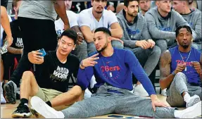  ?? RANDY BELICE / NBAE/GETTY IMAGES ?? Top: Dirk Nowitzki of the Dallas Mavericks high-fives a fan during the NBA Cares Special Olympics Basketball Clinic as part of the 2018 China Games on Thursday at the Oriental Sports Center in Shanghai. Above: Point guard Ben Simmons of the Philadelph­ia 76ers takes a selfie with a fan during the NBA Fan Appreciati­on Day on Thursday in Shanghai.