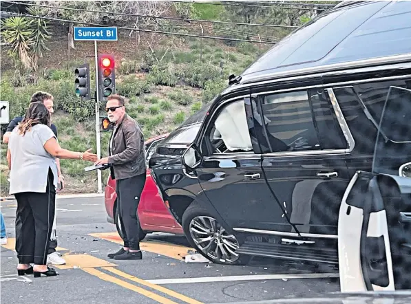  ?? ?? Arnold Schwarzene­gger, the actor and former governor of California, after the incident at a junction on Sunset Boulevard, in Los Angeles, in which his black SUV rolled on top of a red Toyota Prius and a Porsche Cayenne