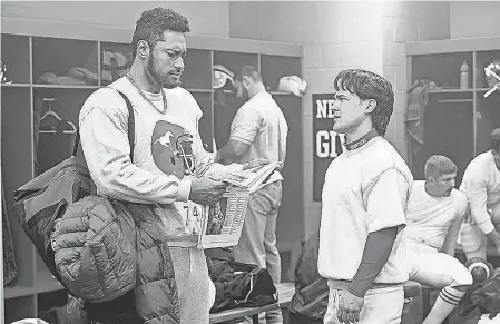  ?? PROVIDED BY MARK TAYLOR/ NBC ?? Uli Latukefu, left, as Dwayne Johnson talks to Victor Gralak as Doug Flutie in “Young Rock.”