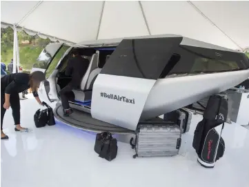  ?? — AFP photo ?? In this file photo an attendee gets into a full sized model of Bell’s unnamed air taxi cabin concept at the second annual Uber Elevate Summit, in Los Angeles, California.