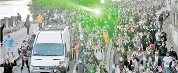  ?? AFP photo ?? People follow a truck with a techno sound system and a laser after a march in memory of Steve Maia Canico, in Nantes, western France. —