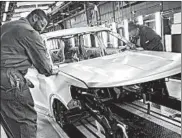  ?? JIM YOUNG/GETTY-AFP ?? Workers build cars at the Ford Chicago Assembly Plant. Manufactur­ing fell in June to the lowest level in three years.