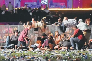  ?? DAVID BECKER / GETTY IMAGES VIA AFP ?? Concertgoe­rs scramble for shelter at the Route 91 country music festival after gunfire breaks out on Sunday in Las Vegas, Nevada.