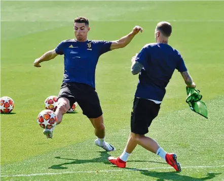  ?? — Reuters ?? Having a ball: Juventus’ Cristiano Ronaldo (left) during a training session at their training centre in Turin yesterday.