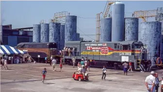  ?? Two photos, John Fravert ?? The South Louisville Shops celebrated 75 years with an open house in August 1980. Locomotive­s old and new were exhibited, including Monon BL2 No. 32 and L&N U23B No. 2803, which shop forces rebuilt after a wreck and painted specially for the occasion.