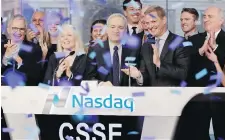  ??  ?? Chicken Soup for the Soul Entertainm­ent CEO William Rouhana, centre, rings the opening bell at the Nasdaq MarketSite in New York on Friday to mark his company’s initial public offering.