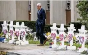  ?? MICHAEL HENNINGER / THE NEW YORK TIMES ?? A mourner visits a makeshift memorial Monday outside Pittsburgh’s Tree of Life Congregati­on, where 11 died in a shooting rampage Saturday. Robert Bowers is charged with 44 counts.