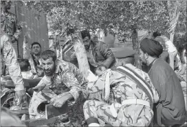  ?? AP PHOTO ?? In this photo provided by the Iranian Students’ News Agency, ISNA, Iranian armed forces members and civilians take shelter in a shooting during a military parade marking the 38th anniversar­y of Iraq’s 1980 invasion of Iran, in the southweste­rn city of Ahvaz, Iran, Saturday.