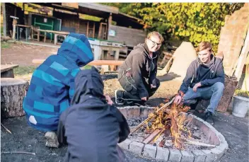  ?? RP-FOTOS (3): ANNE ORTHEN ?? Auf dem Abenteuers­pielplatz in Oberkassel dürfen die Kinder auch mal ein Feuer entfachen – unter Aufsicht von Absolvente­n eines freiwillig­en sozialen Jahres.