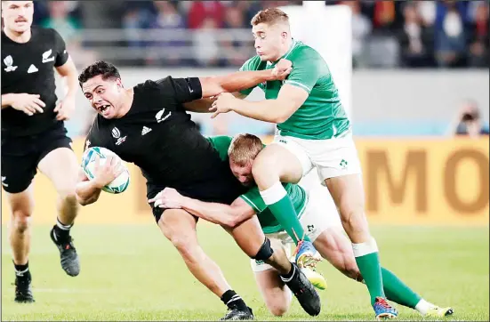  ?? (AP) ?? New Zealand’s Anton Lienert-Brown carries the ball against Ireland defense during the Rugby World Cup quarter-final match at Tokyo Stadium between New Zealand and Ireland in Tokyo,
Japan on Oct 19.