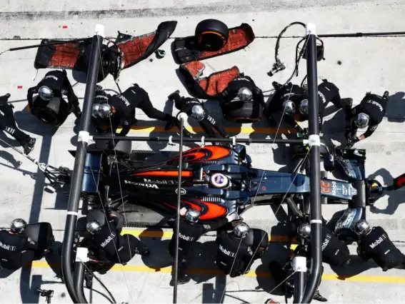  ??  ?? Every milisecond counts when McLaren’s pit team are at work