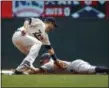  ?? BRUCE KLUCKHOHN — THE ASSOCIATED PRESS ?? Minnesota Twins second baseman Brian Dozier tags out New York Yankees Brett Gardner on an attempted stolen base in the first inning of a baseball game Wednesday in Minneapoli­s.