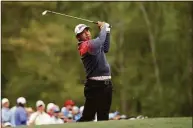  ?? Jamie Squire / Getty Images ?? Hideki Matsuyama plays his shot from the 12th tee during the second round of the Masters on Friday.