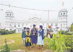  ??  ?? Sikh pilgrims visit the shrine in Nankana Sahib, some 75 kilometres west of Lahore on Thursday, on the occasion of the 550th birth anniversar­y of Guru Nanak.