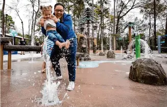  ?? Brett Coomer/Staff photograph­er ?? Takeisha Ivery, a Bear Branch Park recreation supervisor, plays with Blakely Palomino, 2, during the official opening of the park’s spraygroun­d on Thursday.