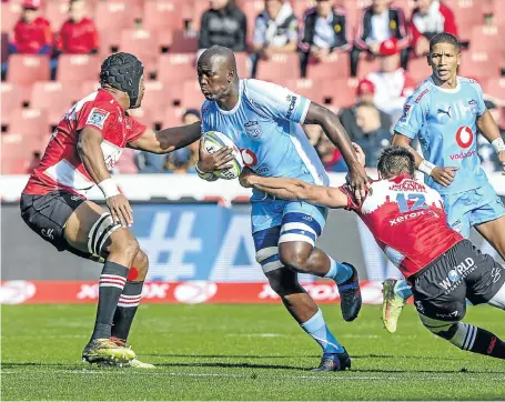  ?? Picture: Sydney Seshibedi/Gallo Images ?? Bulls flanker Thembelani Bholi attempts to break a Lions tackle by centre Harold Vorster, but another lies in wait during the Super Rugby match at Ellis Park yesterday. The Lions won 38-19 and scored six tries in the process