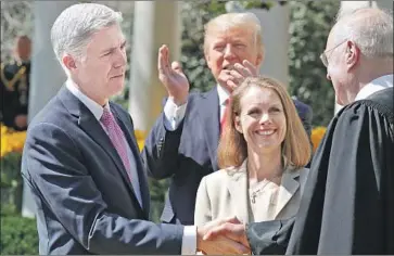  ?? Chip Somodevill­a Getty Images ?? NEIL M. GORSUCH is congratula­ted by Justice Anthony M. Kennedy in 2017 after being sworn in to the Supreme Court. The Senate fight over Kennedy’s replacemen­t is likely to be a major campaign issue.