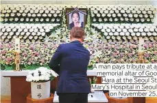  ?? Photos by AP. AFP and Reuters ?? A man pays tribute at a memorial altar of Goo Hara at the Seoul St Mary’s Hospital in Seoul on November 25.