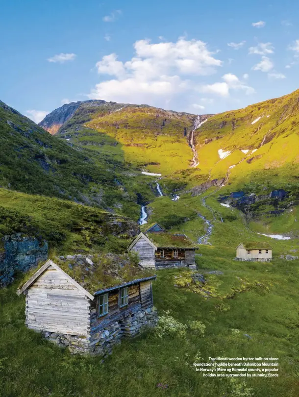  ??  ?? Traditiona­l wooden hytter built on stone foundation­s huddle beneath Dalsnibba Mountain in Norway’s Møre og Romsdal county, a popular holiday area surrounded by stunning fjords