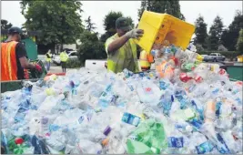  ?? KRISTOPHER SKINNER — BAY AREA NEWS GROUP ARCHIVES ?? Michael Lujano dumps plastic bottles into the hopper to be weighed as he handles a customer’s recyclable­s at the Tri-CED recycling facility in Union City.