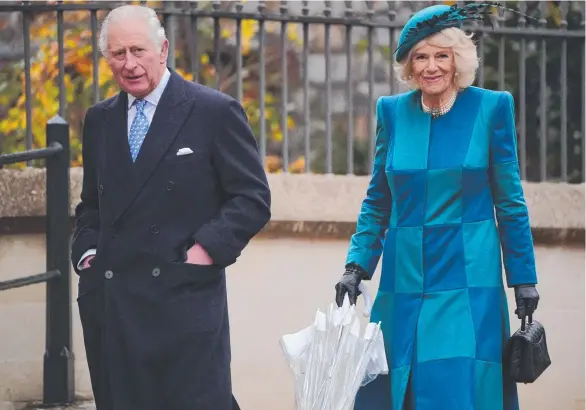  ?? ?? The Prince of Wales and the Duchess of Cornwall attend a Christmas Day church service at St George's Chapel. Pic: Jonathan Brady / POOL / AFP.