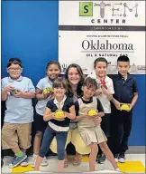  ?? [PROVIDED] ?? A teacher who is the STEM coordinato­r at Oklahoma City's Eugene Field Elementary School and some of her students show off robotic bees they will learn how to program at the Ripken Foundation STEM center at the school.